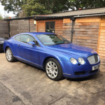 Blue Bentley with silver alloys